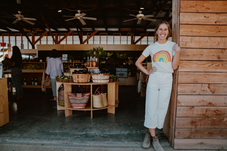 Katie standing in front of the Farm Stand.