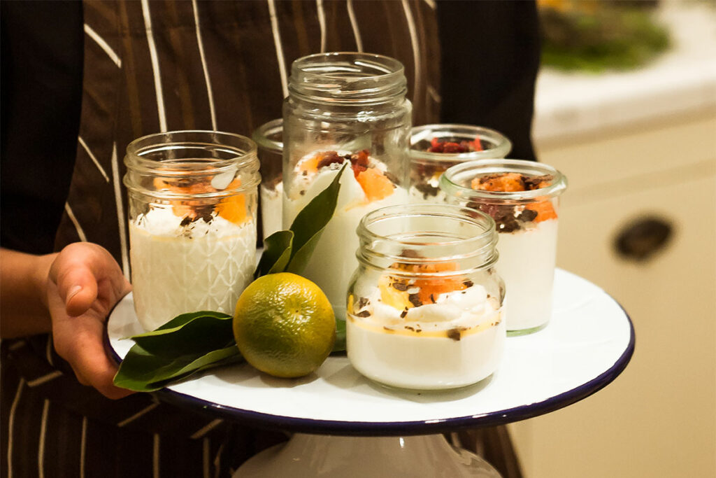 Lemon Mousse and Citrus Compote with Shaved Chocolate served in jars.