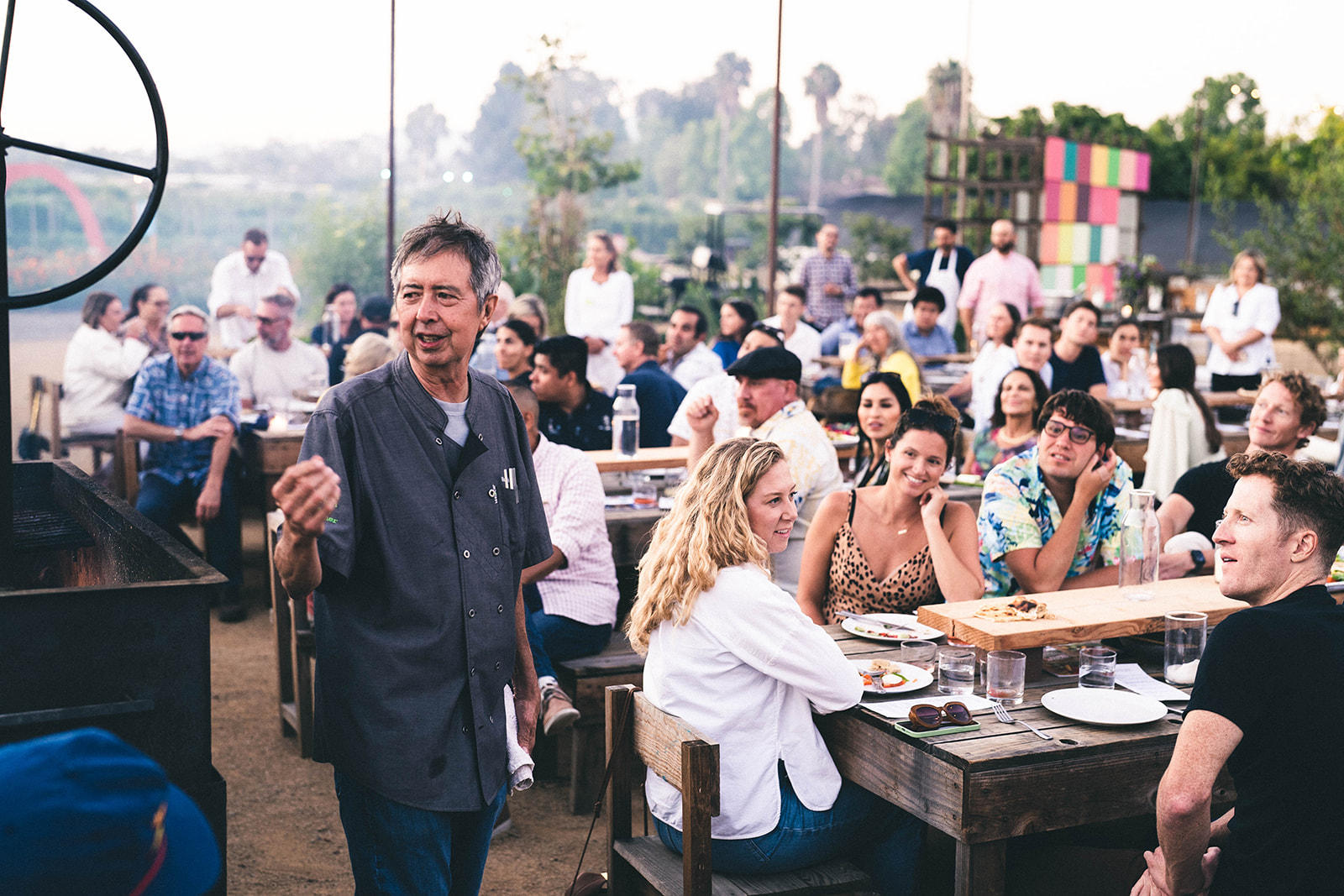 Chef Rich Mead standing in front of a crowd at a Community Table Dinner