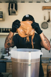 Chef Irving holding up a kombucha SCOBY