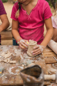 child making clay pottery