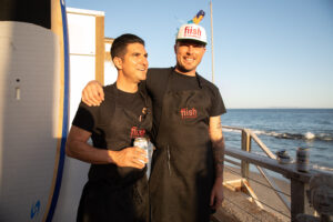 chefs of the restaurant Fiish, standing on a dock in the bay