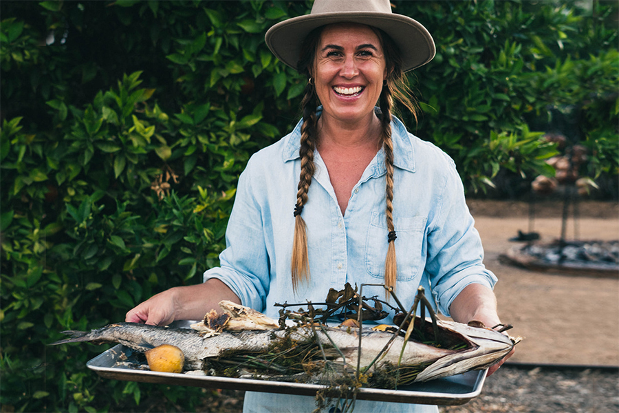 Chef Sarah Glover holding a pan of fish